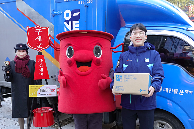 CJ대한통운 오네(O-NE) 배송차량 앞에서 CJ대한통운 직원과 구세군 사관, 구세군 캐릭터 따끈이가 10주년 기념촬영을 하고 있다. 사진 | CJ대한통운