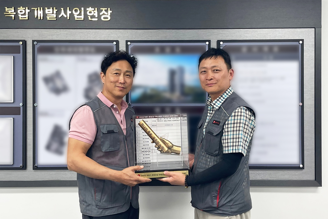 롯데건설 주택안전팀 이승환 상무(왼쪽)가 현장소장에게 ‘안전 바통’을 전달하고 있다. 사진 | 롯데건설