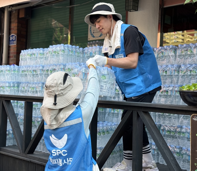 서울 용산구 한강로동 주거단지에서 5일 SPC그룹 임직원들이 폭염으로 어려움을 겪고 있는 취약계층에게 전달할 생수를 나르고 있다. 사진 | SPC