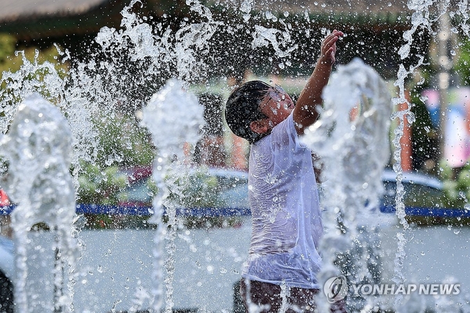 . 티베트고기압이 우리나라를 완전히 덮은 가운데 일본 남쪽 해상에 자리한 북태평양고기압이 고온다습한 공기를 주입하며 무더운 날씨는 당분간 이어지겠다. 서울 한낮 기온이 33도까지 오르며 더운 날씨를 보인 21일 서울 종로구 광화문광장 분수대에서 한 어린이가 물놀이를 즐기고 있다. 사진 ㅣ 연합뉴스