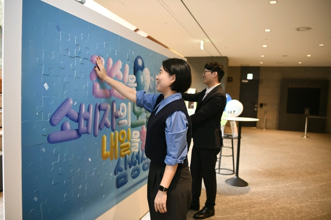 25일 서초구 삼성금융캠퍼스에서 열린 '제1회 금융소비자의 날' 행사에서 삼성생명 임직원들이 고객 섬김의 실천의지를 담아 '월 퍼즐'을 완성하고 있다. 사진 | 삼성생명